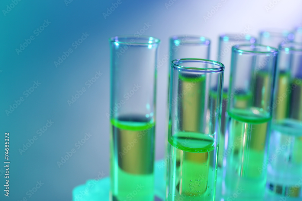 Green fluid in test-tubes on the light background Green fluid in test-tubes on the light background