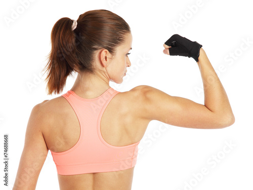 Image of young sporty woman showing her biceps isolated on white