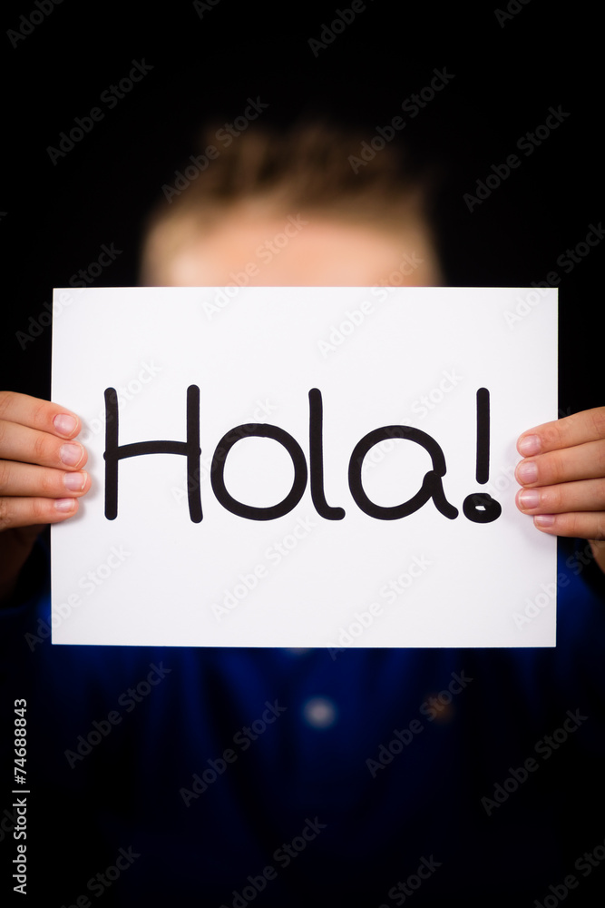 Child holding sign with Spanish word Hola - Hello Child holding sign with Spanish word Hola - Hello