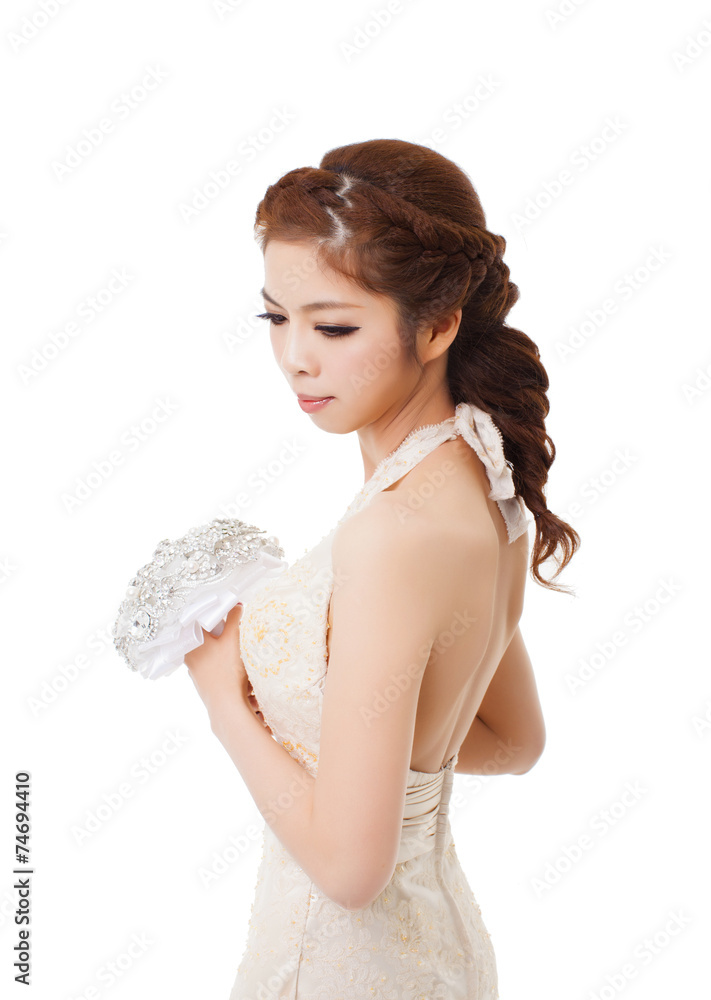 Young  beautiful bride holding flowers