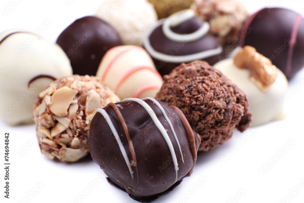 Assortment of chocolates on white background