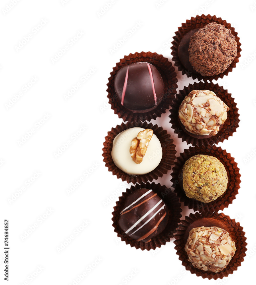 Group of round chocolates in paper bowls isolated Group of round chocolates in paper bowls isolated
