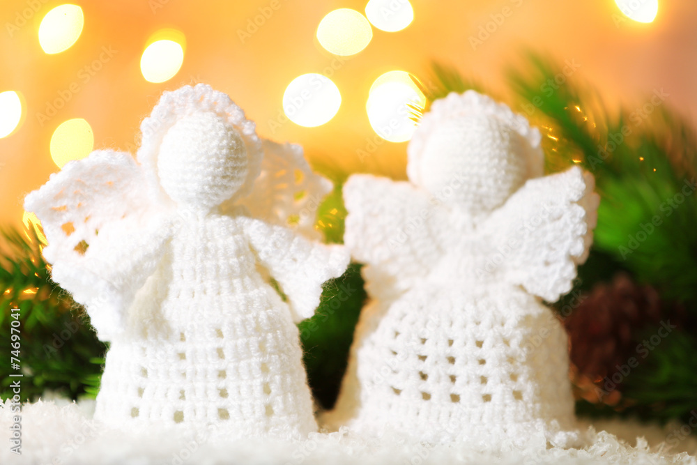 Knitted Christmas angels on bright background Knitted Christmas angels on bright background