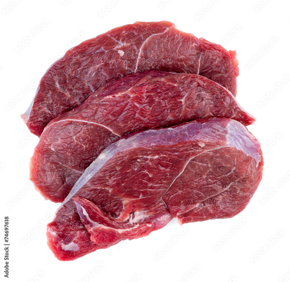 Aerial of raw red meat steaks isolated against a white backgroun