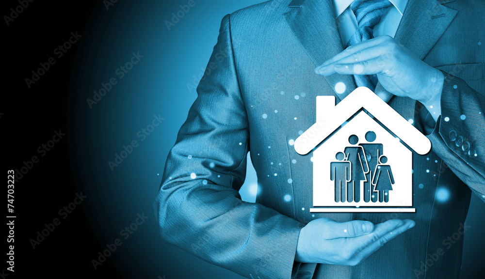 businessman protecting family in home with hands businessman protecting family in home with hands