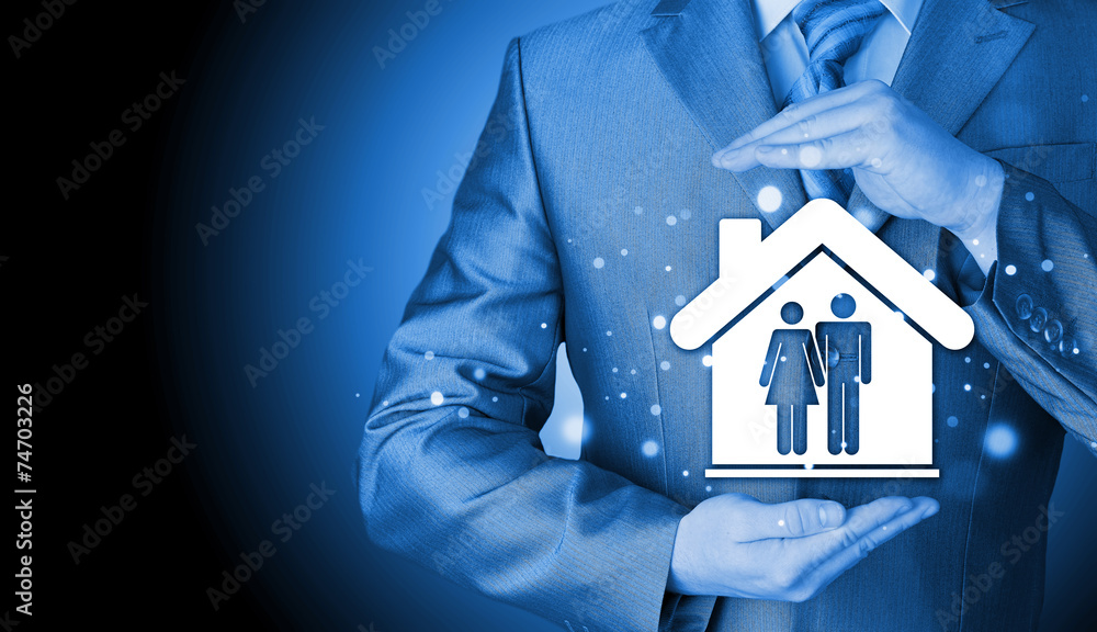 businessman protecting family in home with hands businessman protecting family in home with hands
