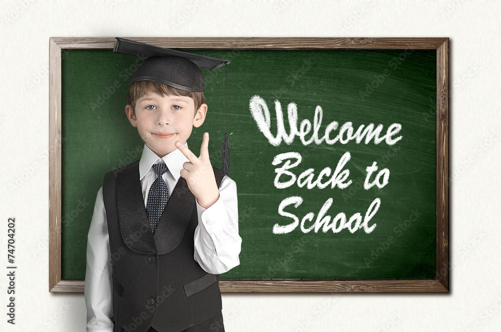 Cheerful little boy on blackboard. Looking at camera Cheerful little boy on blackboard. Looking at camera