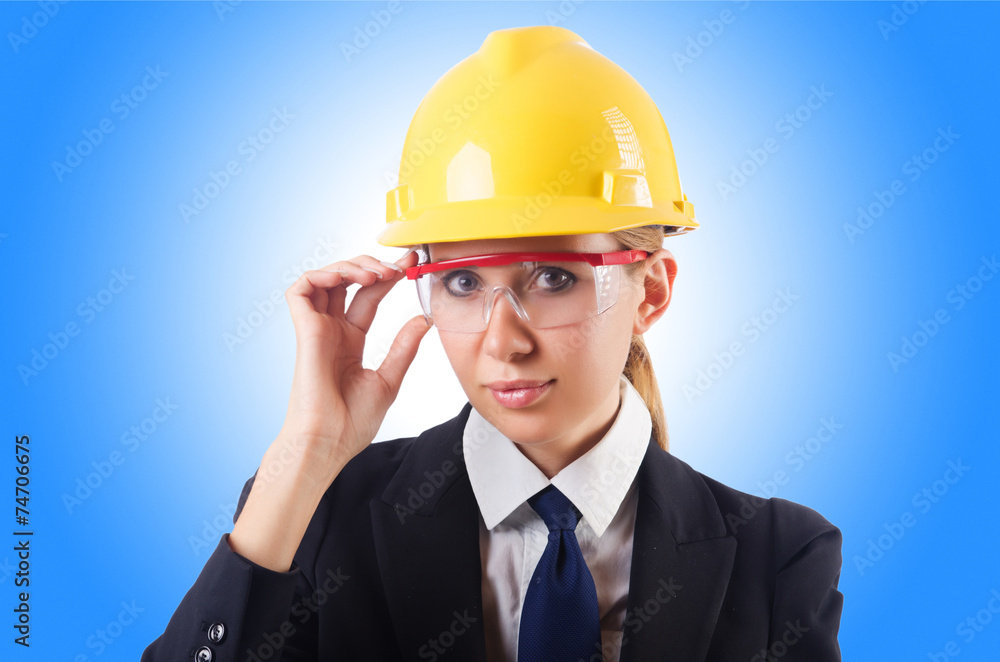 Young businesswoman with hard hat on white Young businesswoman with hard hat on white