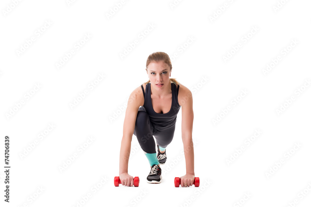 Beautiful athlete squatting with dumbbells Beautiful athlete squatting with dumbbells