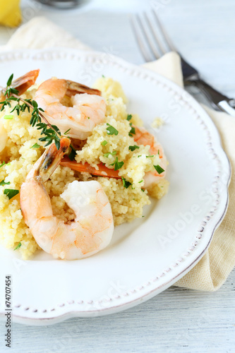 Tasty couscous with shrimp on the plate