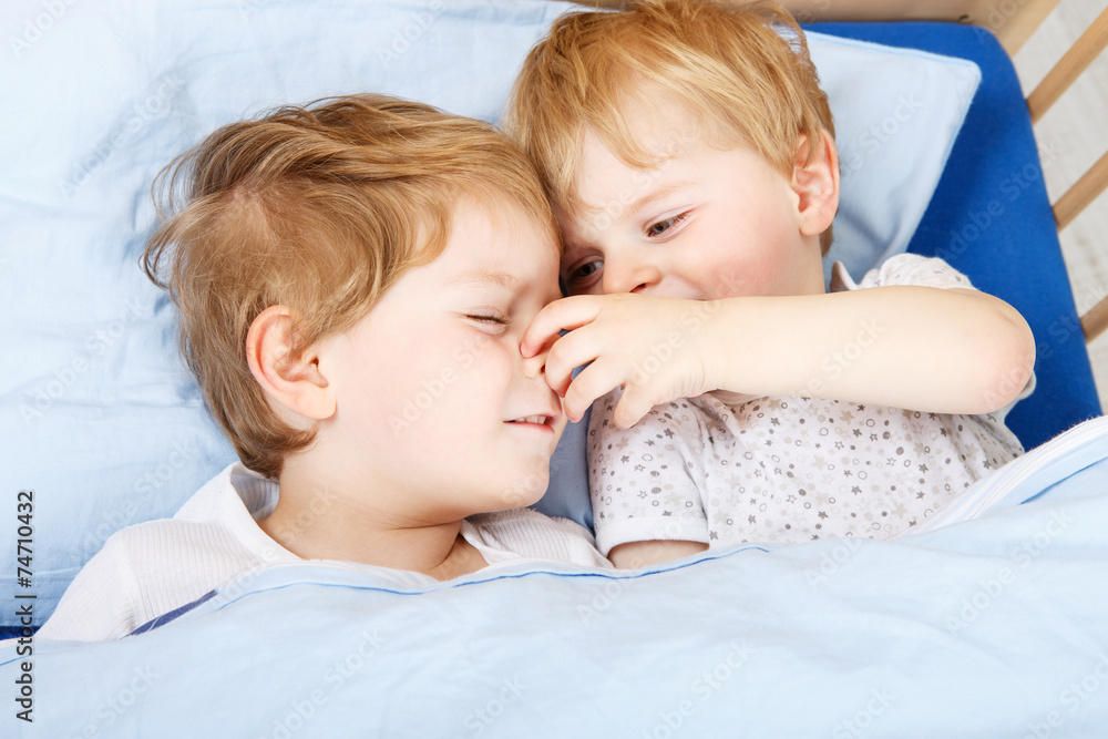 little sibling boys having fun in bed at home little sibling boys having fun in bed at home