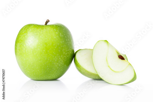 Green apples and apple slices isolated on white.