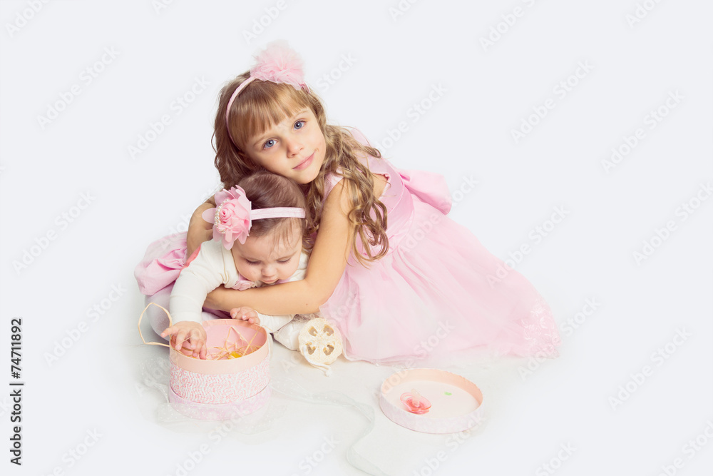Adorable little sister hugging her baby sister Adorable little sister hugging her baby sister