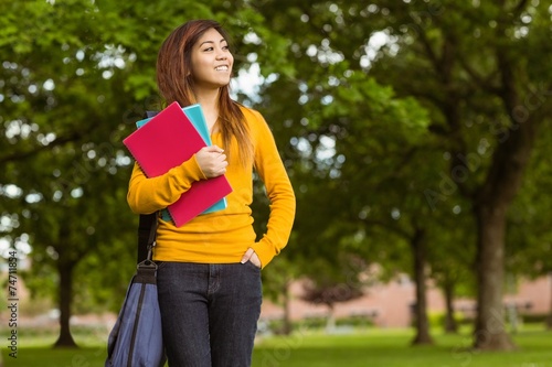 Female college student with books in park