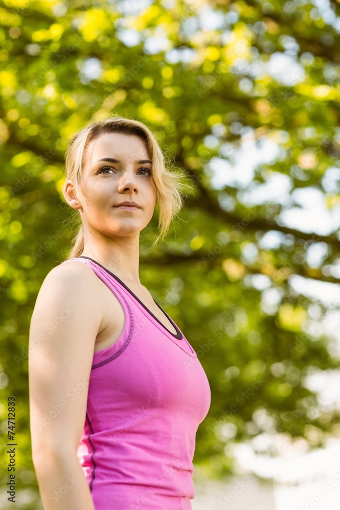 Fit blonde standing in the park Fit blonde standing in the park