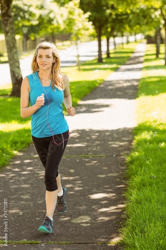 Fototapeta Naklejka Na Ścianę i Meble -  Fit blonde jogging in the park