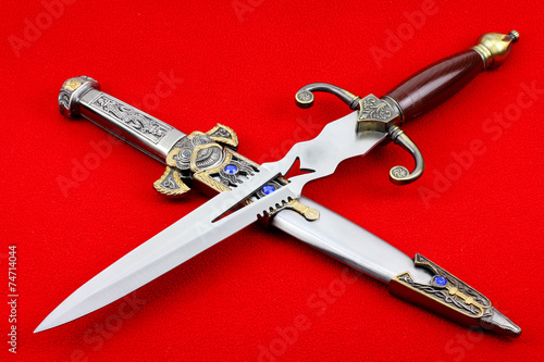 Two dagger on a red background.