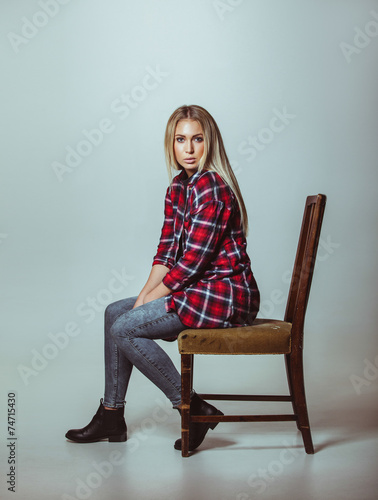 Beautiful young woman sitting on chair © Jacob Lund