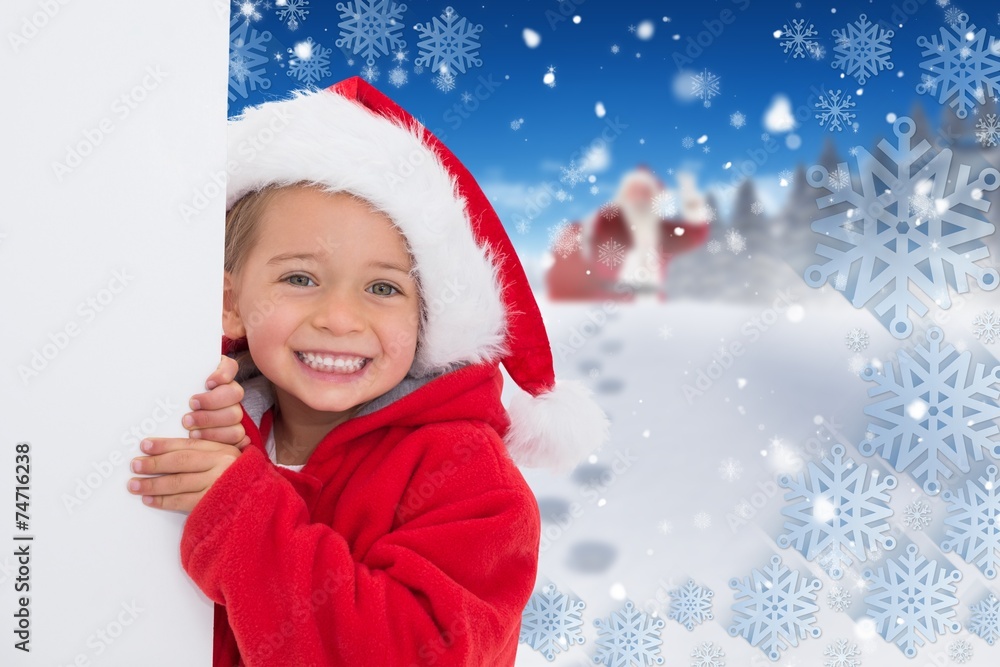 Composite image of festive little girl showing poster Composite image of festive little girl showing poster