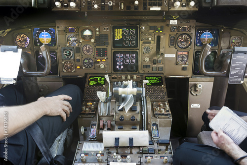 Cockpit and pilots getting ready to start flying photo