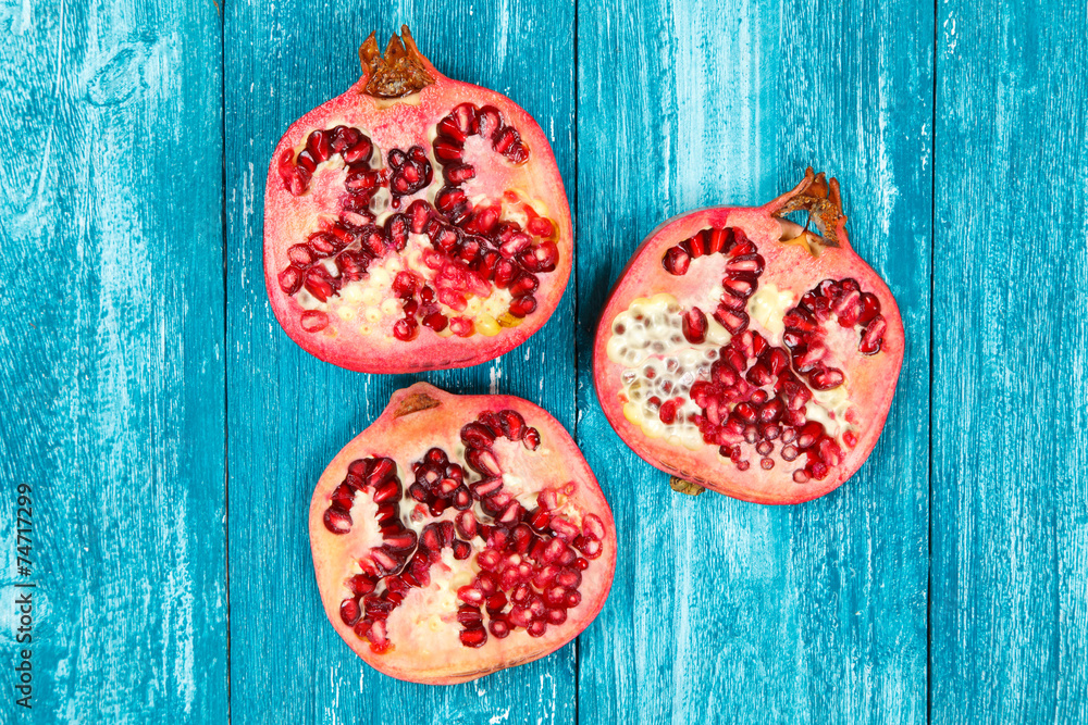 Fresh pomegranate on blue wood Fresh pomegranate on blue wood