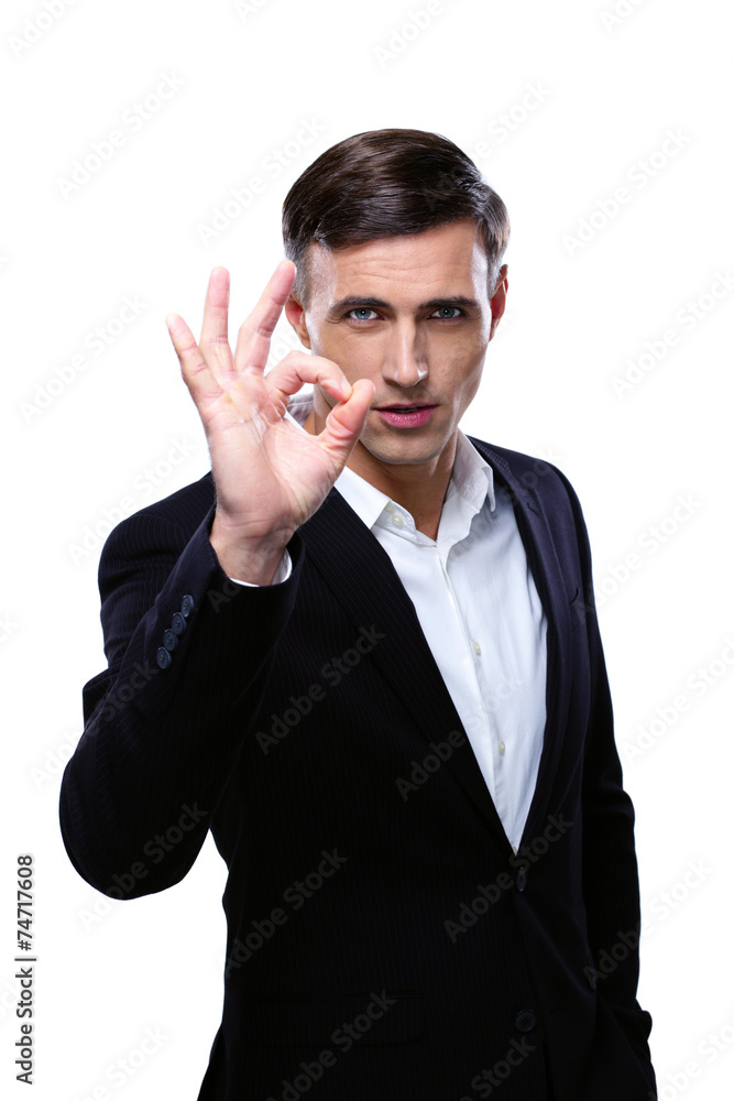 Happy young businessman gesturing OK sign over white background Happy young businessman gesturing OK sign over white background