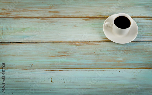 Coffee cup on blue wooden background