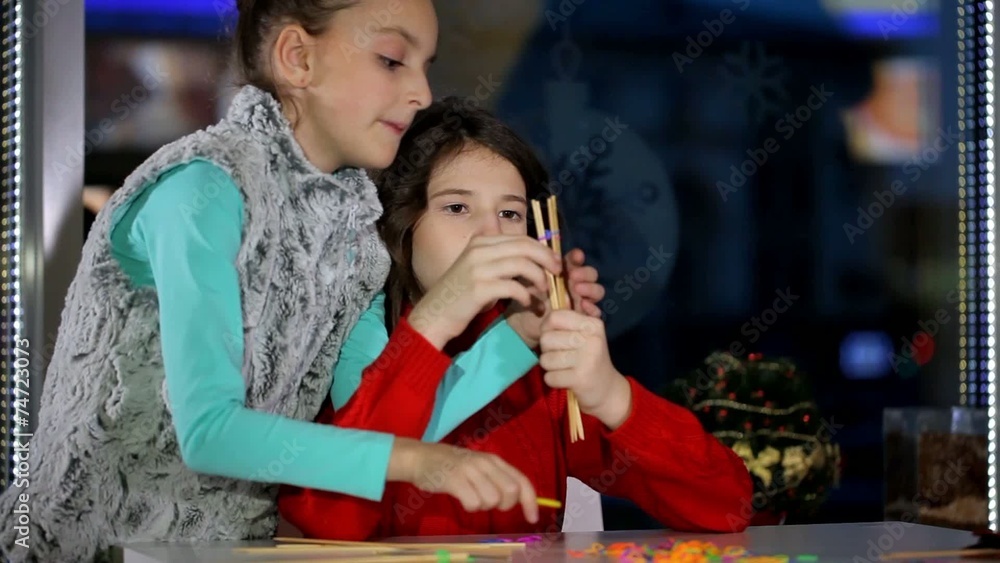 Girl girlfriend teaches creative weaving of threads Girl girlfriend teaches creative weaving of threads