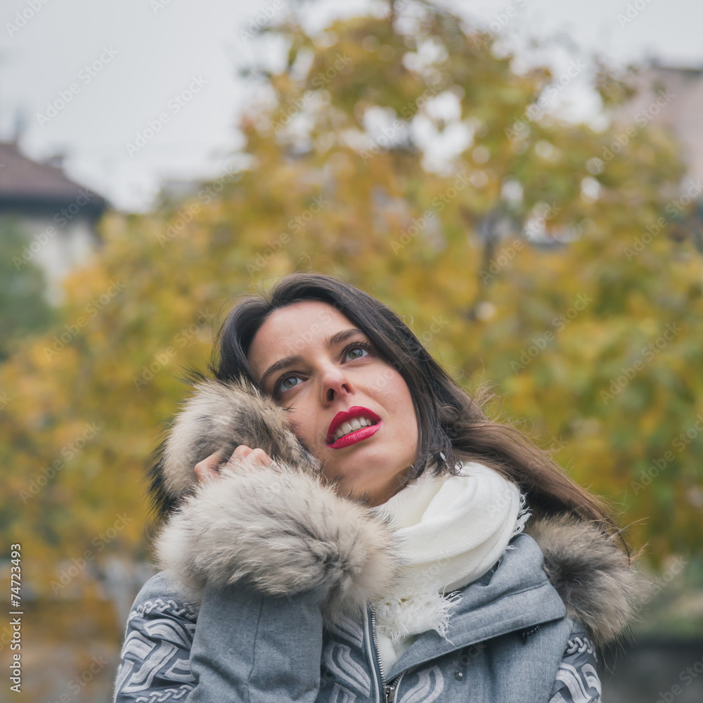 Beautiful young brunette posing in the city streets Beautiful young brunette posing in the city streets