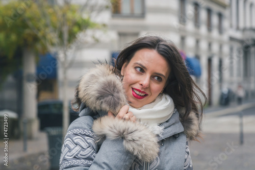 Beautiful young brunette posing in the city streets