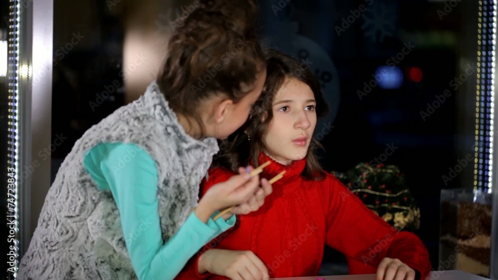 Girl girlfriend teaches creative weaving of threads
