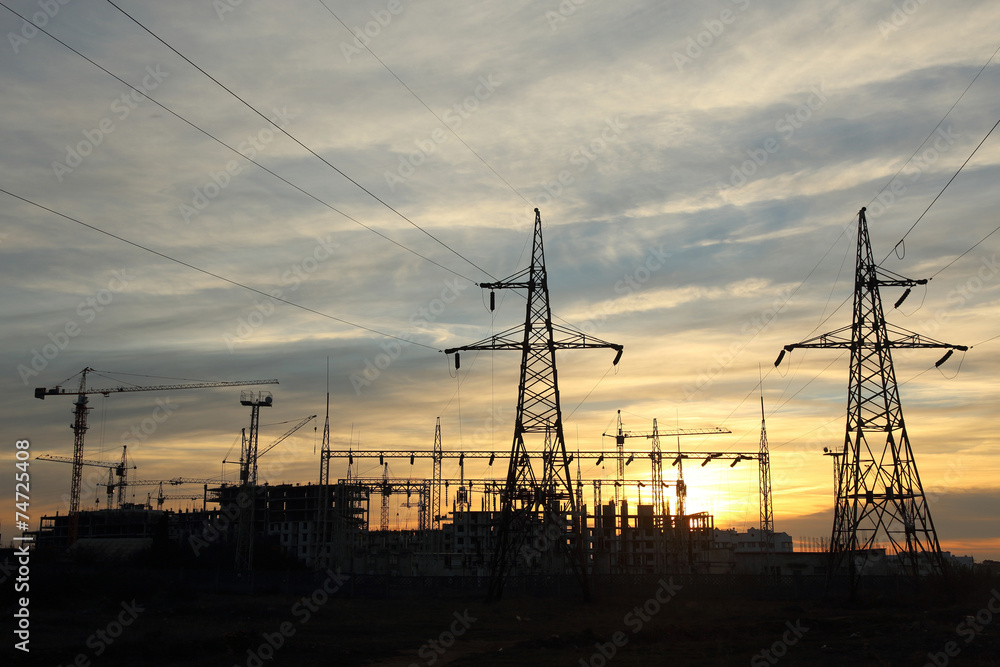 silhouette of construction and power lines at sunset