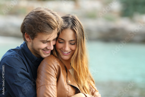 Foto Couple cuddling affectionate on the beach