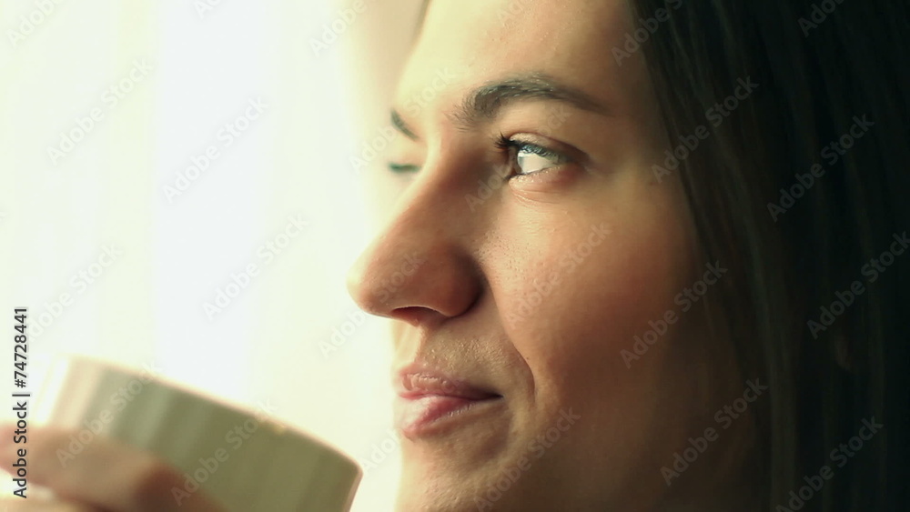Beautiful girl drinking tea or coffee, close up Beautiful girl drinking tea or coffee, close up