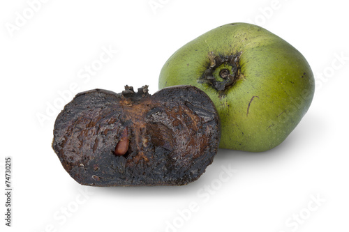 Whole and partial black sapote fruit
