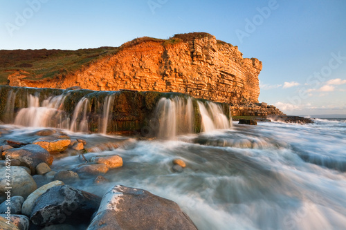 Waterfall on Monknash beach in Glamorgan, Wales, UK. © milangonda