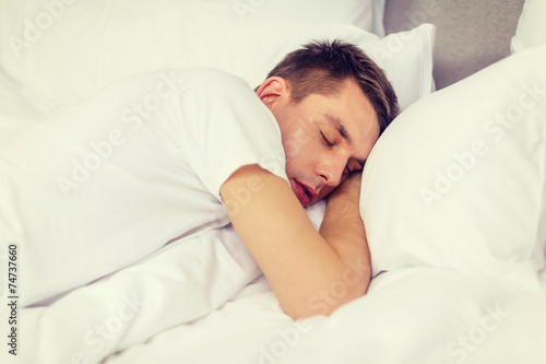 handsome man sleeping in bed