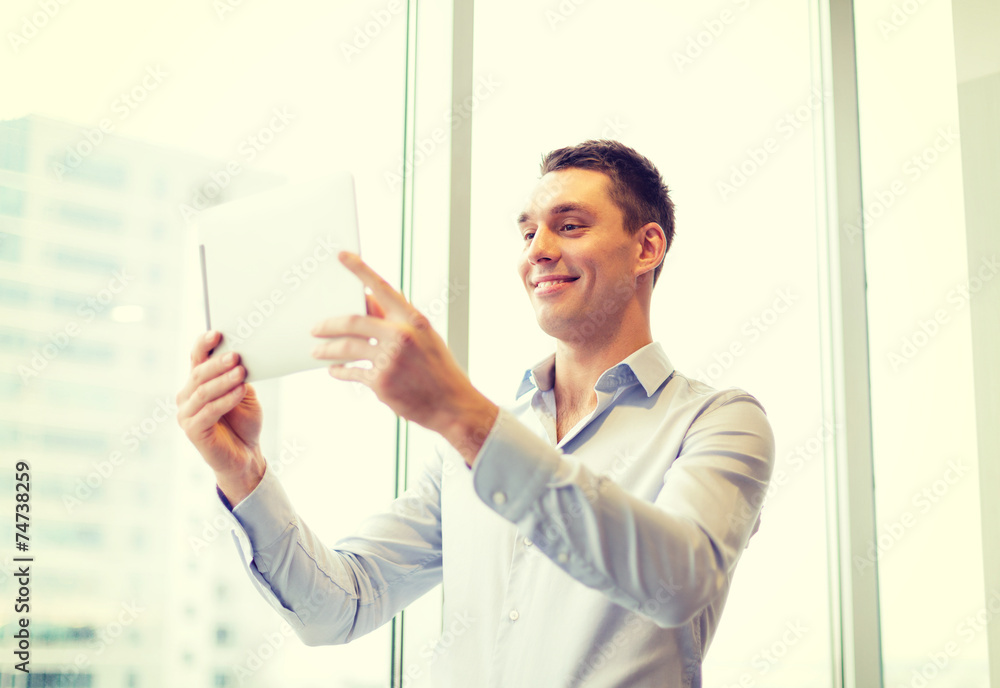 smiling businessman with tablet pc in office smiling businessman with tablet pc in office