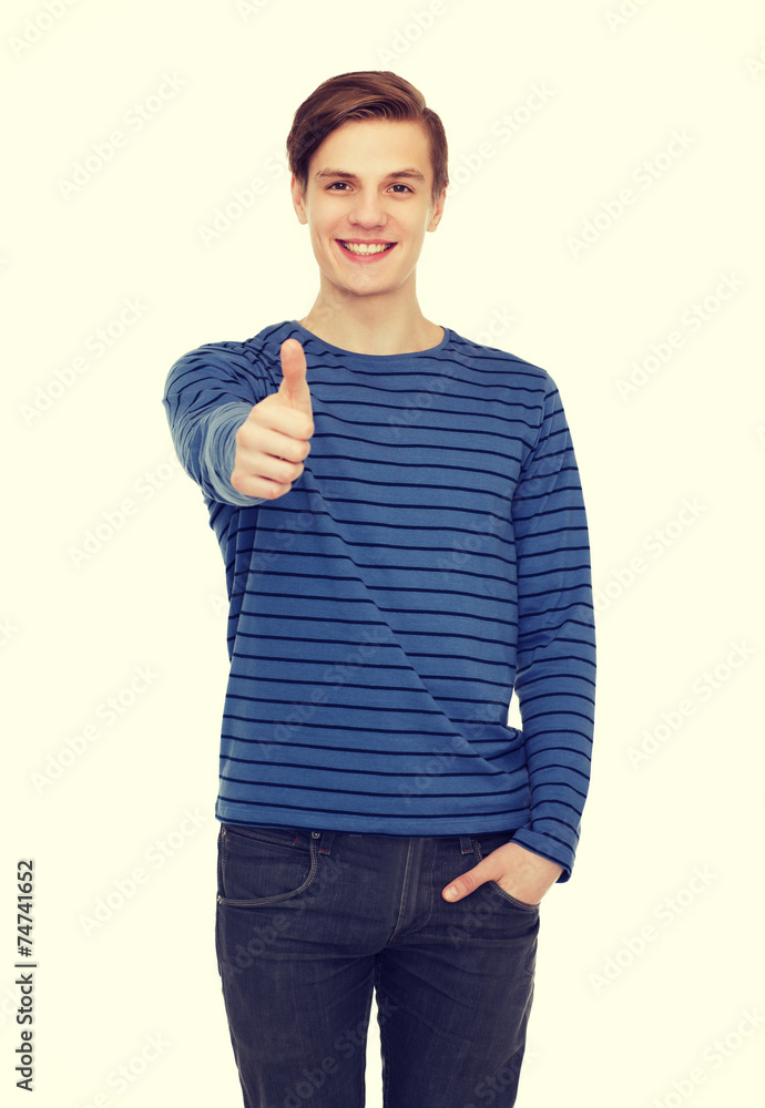 smiling teenage boy showing thumbs up smiling teenage boy showing thumbs up