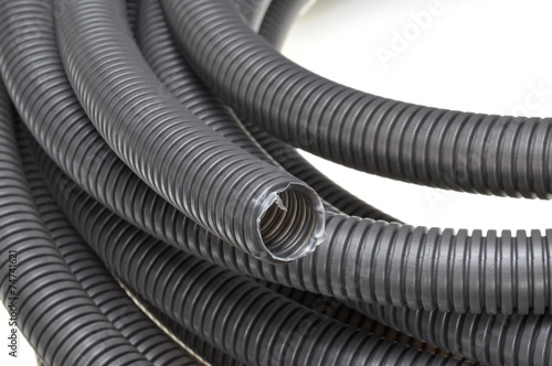 Black corrugated pipes isolated on white background