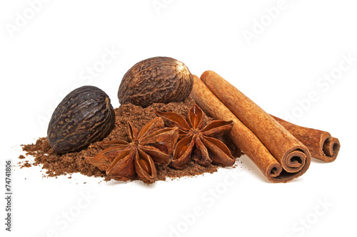 Anise, cinnamon sticks and nutmeg on a white background