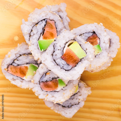 inside out sushi roll with salmon and avocado photo