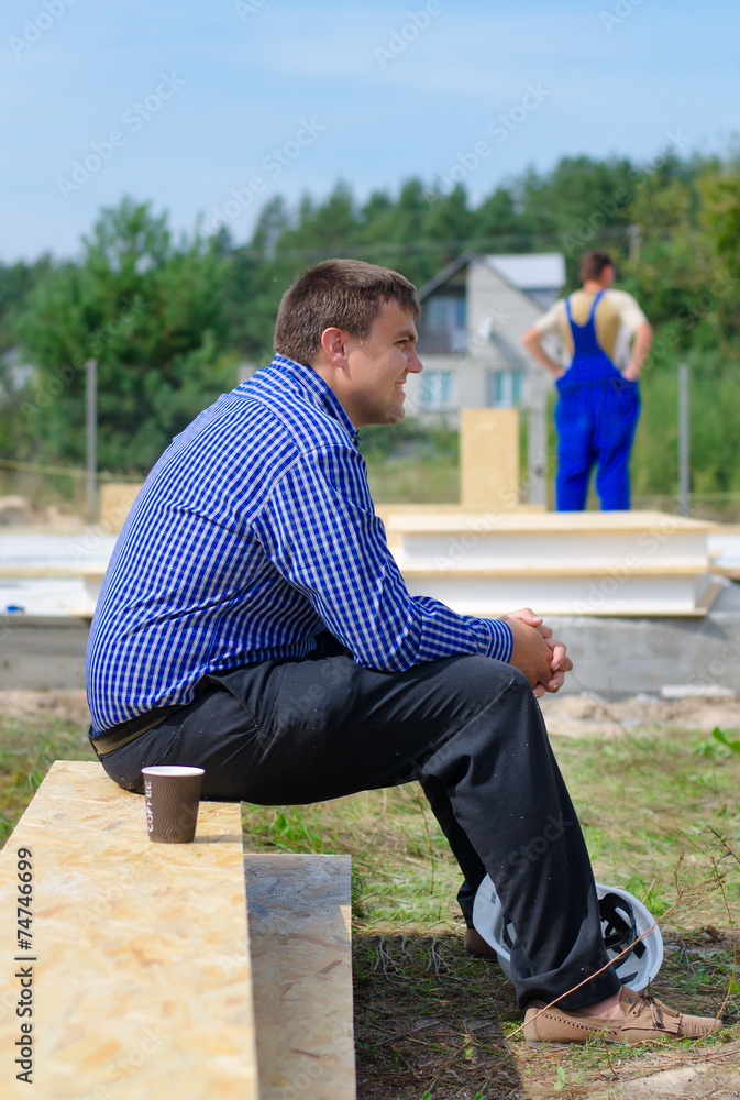 Engineer relaxing during a break on site Engineer relaxing during a break on site