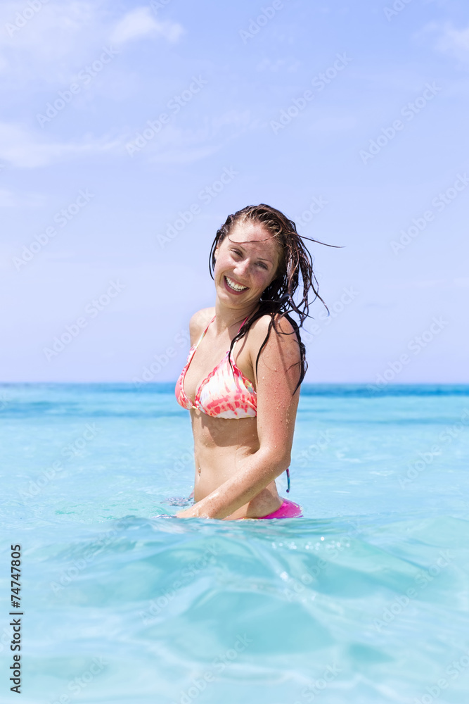 Beautiful girl smiling in the ocean in bikini Beautiful girl smiling in the ocean in bikini