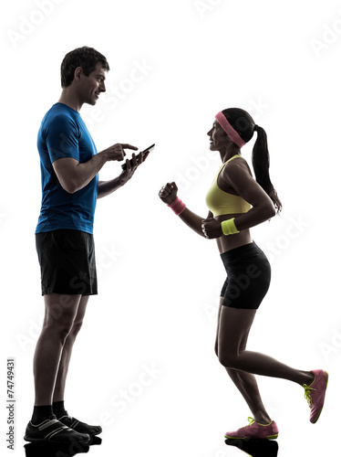 woman exercising jogging man coach using digital tablet silhoue