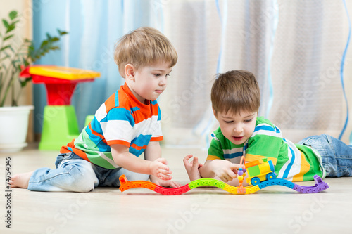 children playing rail road toy