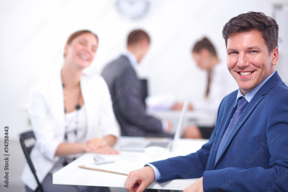 Beautiful young business people with colleagues discussing in Beautiful young business people with colleagues discussing in