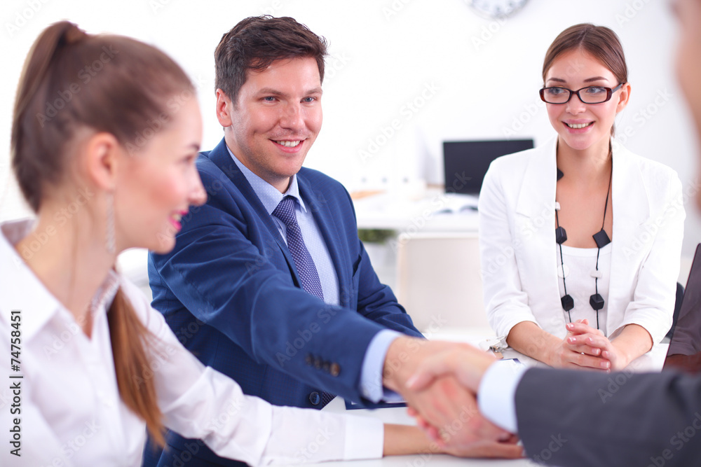 Business people shaking hands, finishing up a meeting Business people shaking hands, finishing up a meeting