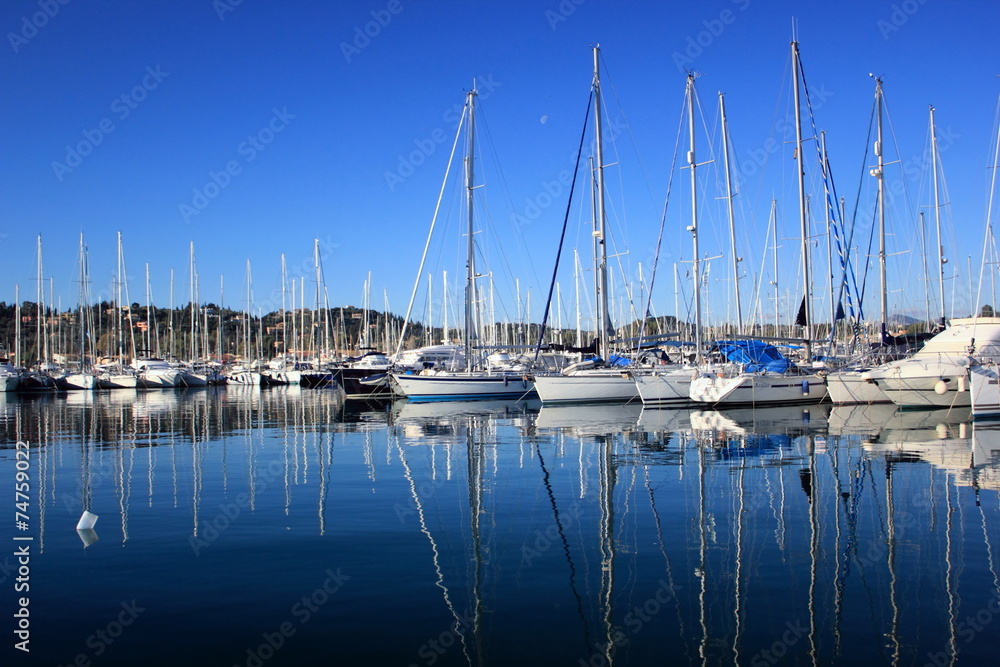 sail Boats and yachts reflected in calm harbour