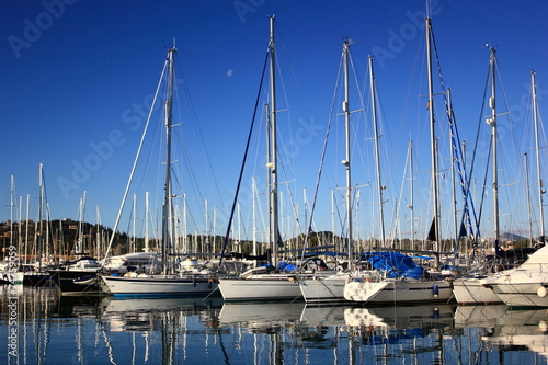 sail Boats and yachts reflected in calm harbour	 photo